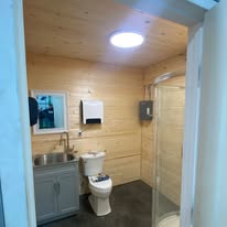 Cabin-style bathroom build-out with wood paneling